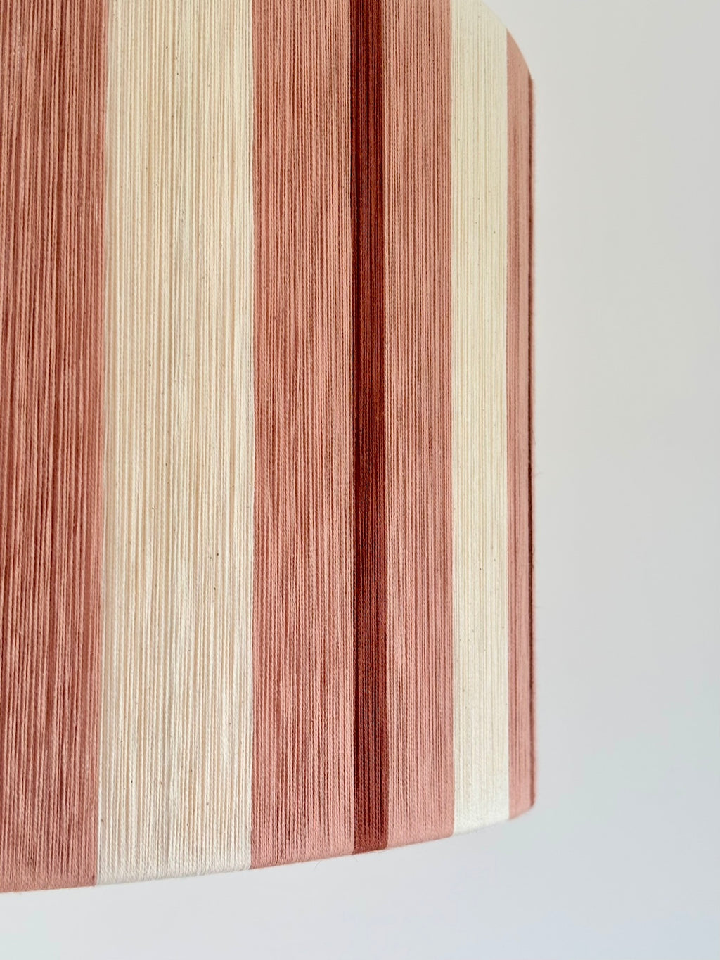 Right-side close-up of the Marnie Drum Large, featuring detailed handwoven yarn in warm striped tones.