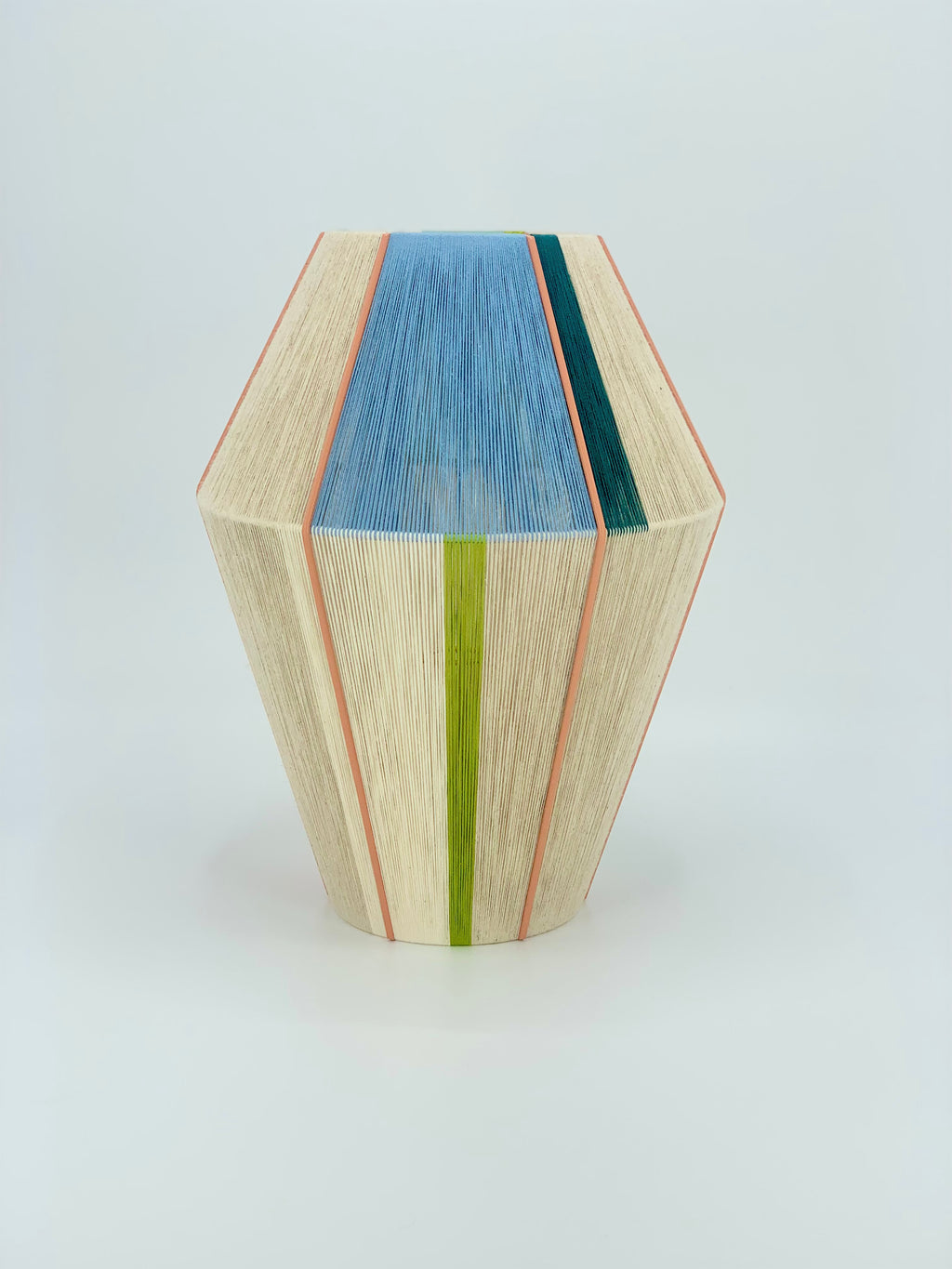 Alice Baya pendant light shown in salmon, blue, green, lime and natural yarns by Skye Lightly.