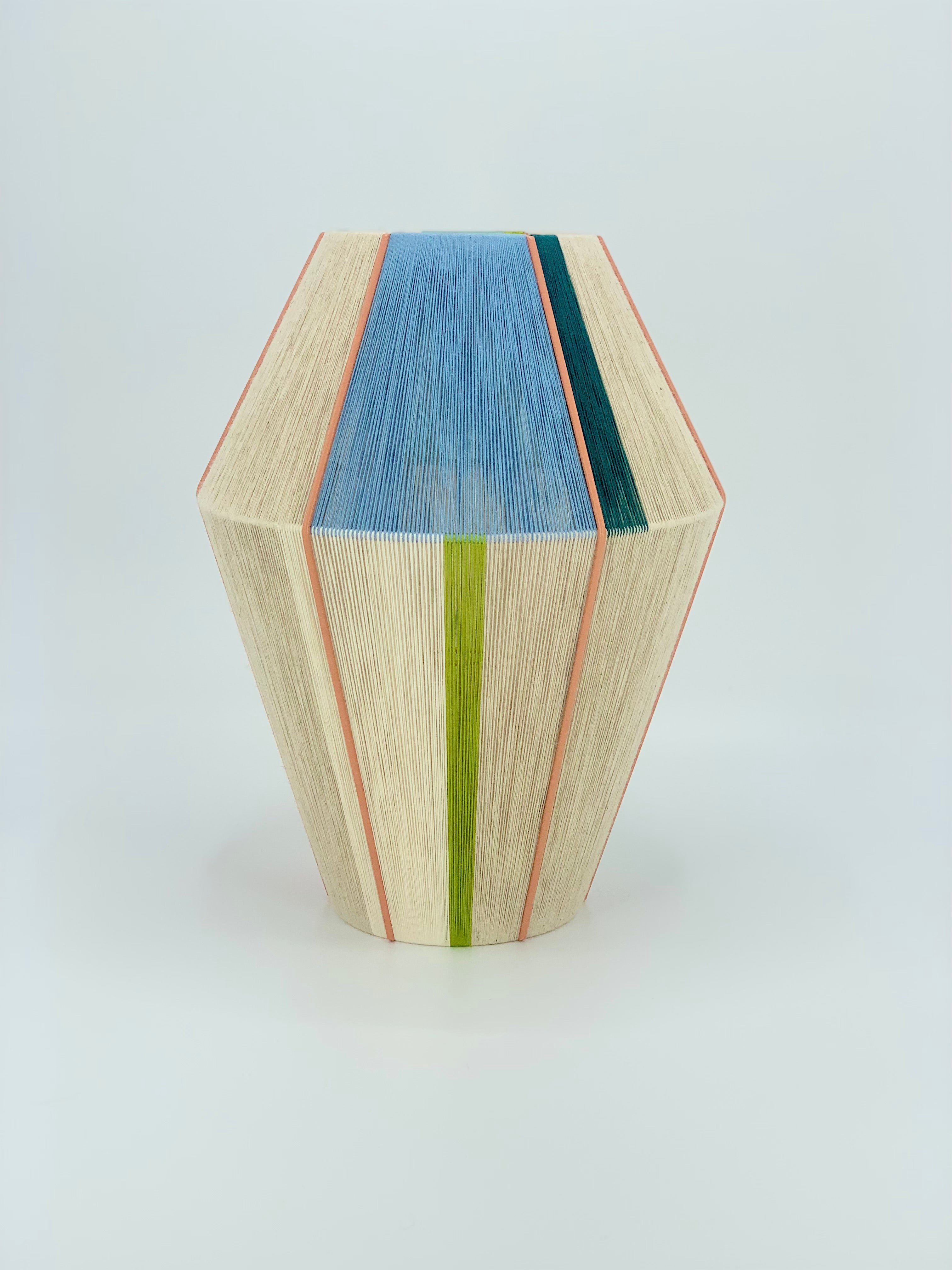 Alice Baya pendant light shown in salmon, blue, green, lime and natural yarns by Skye Lightly.