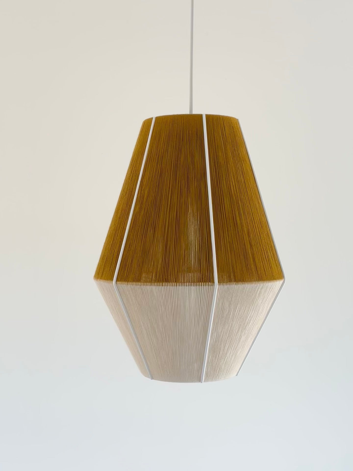 Handwoven Baya pendant light in mustard and natural colours by Skye Lightly