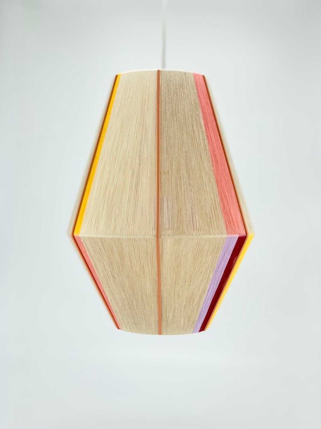 Caroline Baya pendant light in salmon, lavender, yellow, raspberry and natural yarns by Skye Lightly