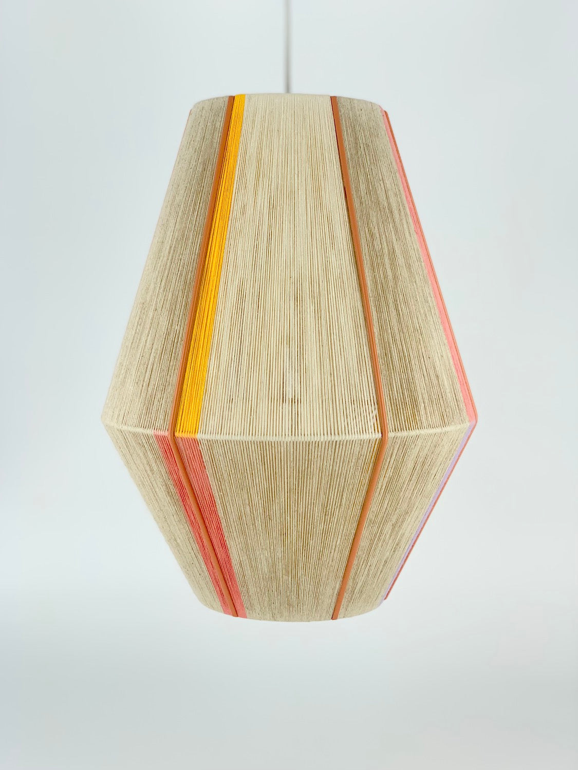 Caroline Baya pendant light in salmon, yellow and natural yarns by Skye Lightly.