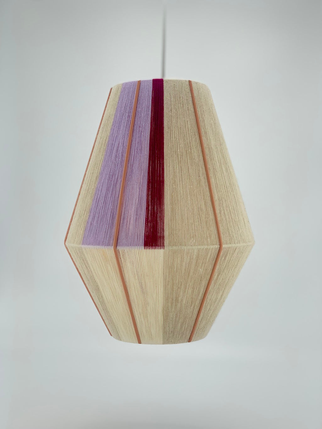Caroline Baya pendant light in lavender, raspberry and natural yarns by Skye Lightly.
