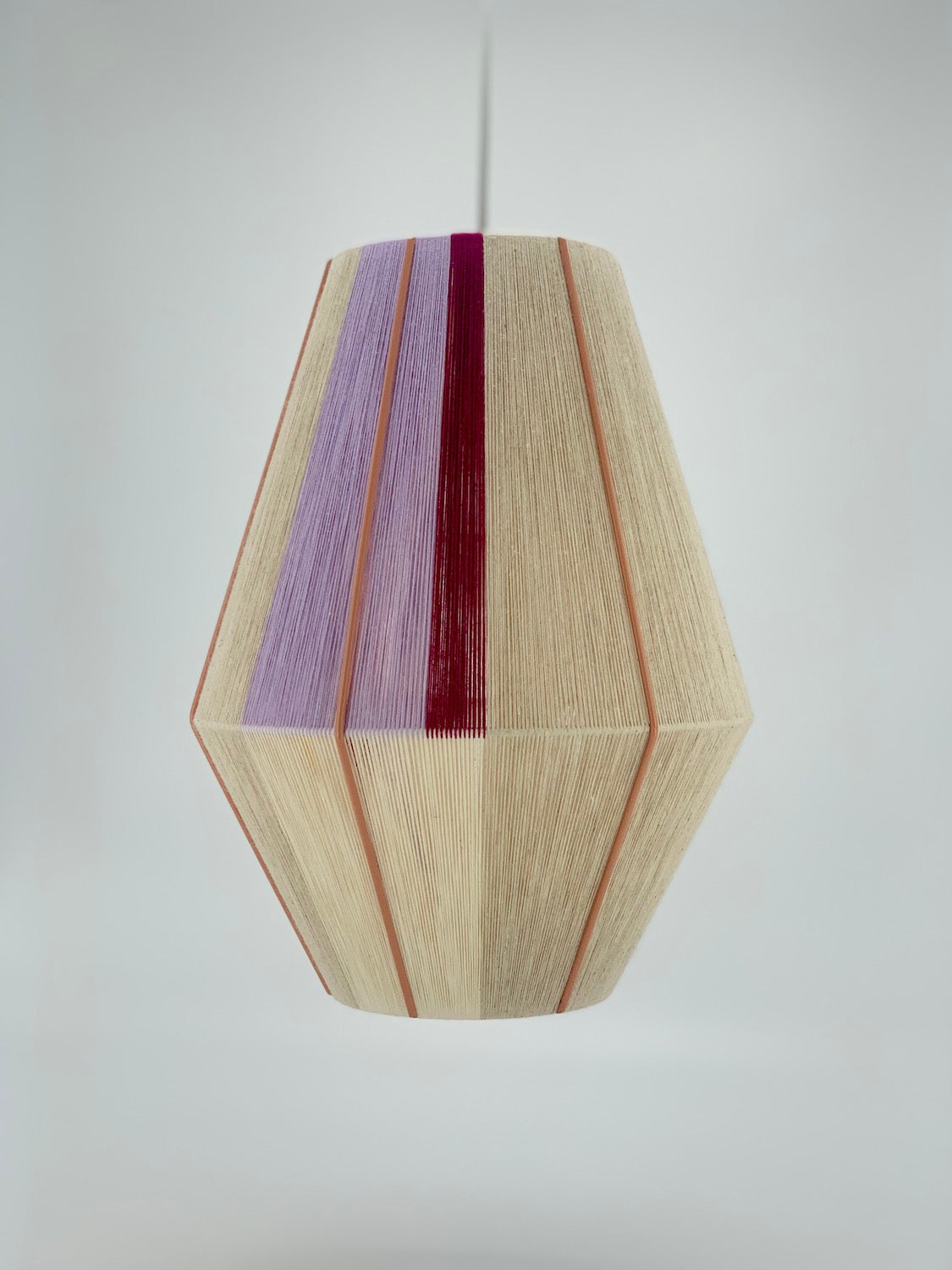 Caroline Baya pendant light in lavender, raspberry and natural yarns by Skye Lightly.
