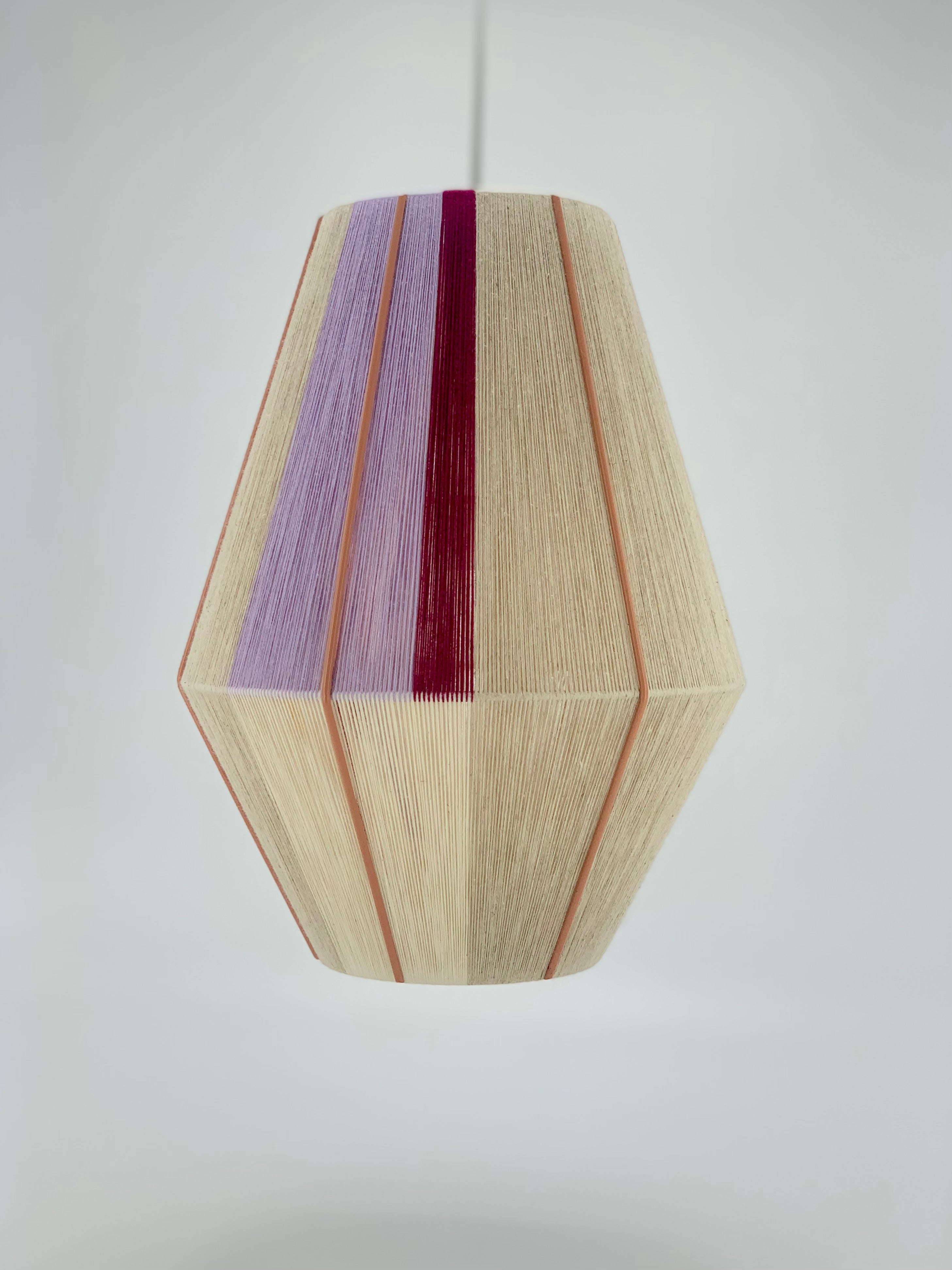 Caroline Baya pendant light handwoven in lavender, raspberry and natural yarns by Skye Lightly.
