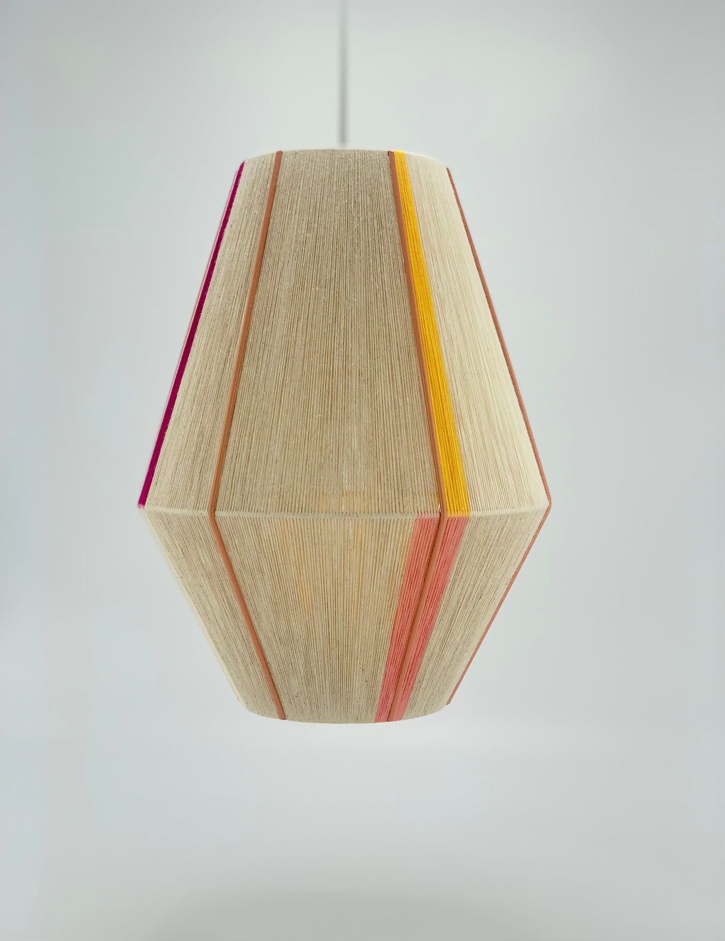 Caroline Baya pendant light in salmon,  yellow, raspberry and natural yarns by Skye Lightly.