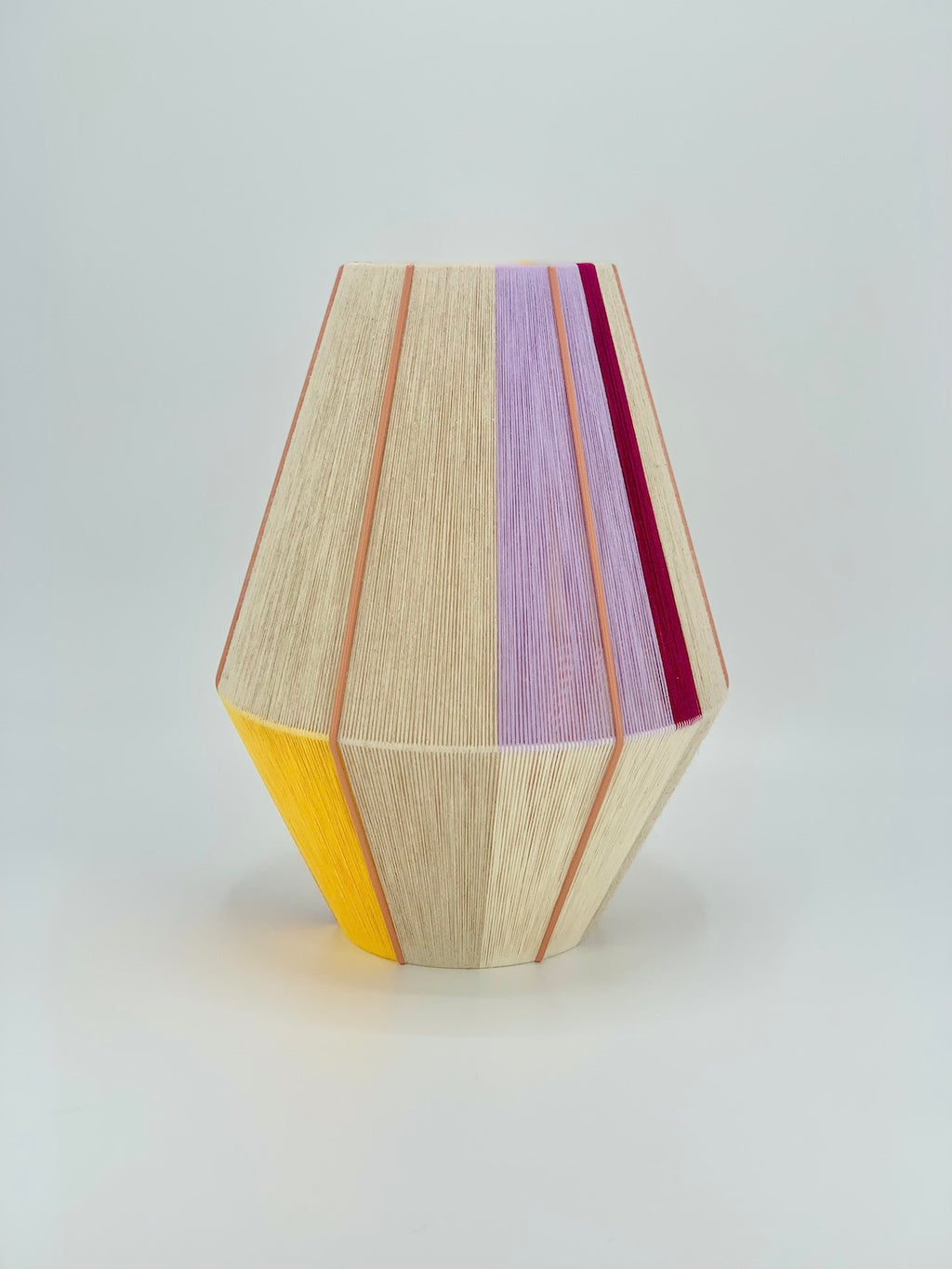 Caroline Baya pendant light in lavender, yellow, raspberry and natural yarns by Skye Lightly.