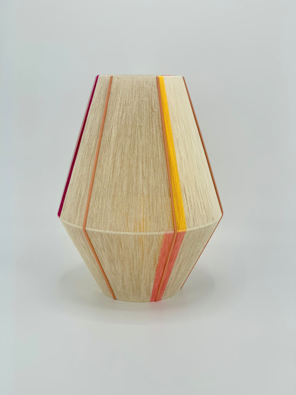Caroline Baya pendant light handwoven in salmon, yellow, raspberry and natural yarns by Skye Lightly.