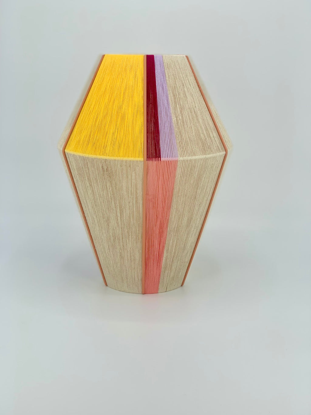Caroline Baya pendant light handwoven in salmon, lavender, yellow, raspberry and natural yarns by Skye Lightly.