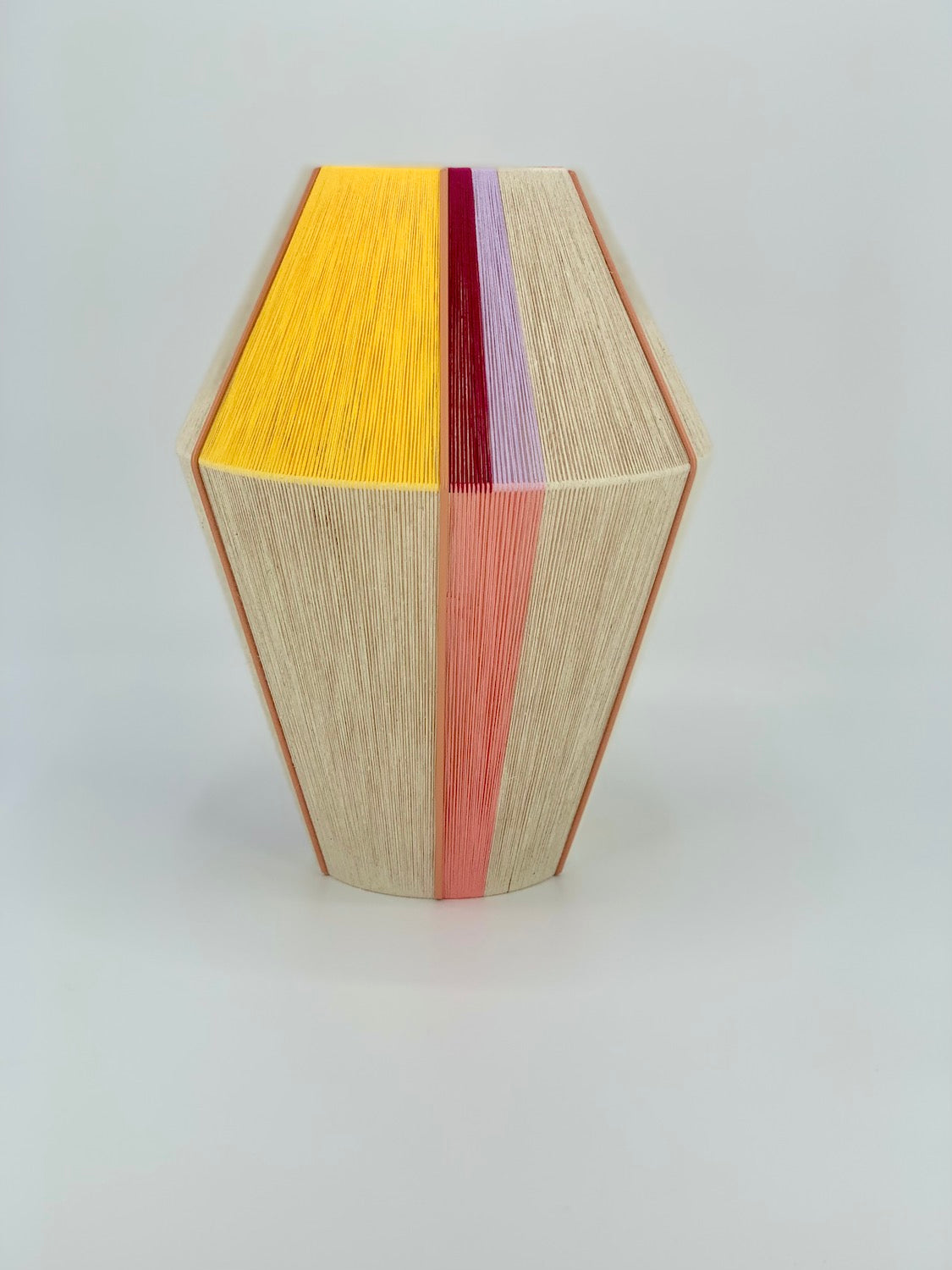 Caroline Baya pendant light handwoven in salmon, lavender, yellow, raspberry and natural yarns by Skye Lightly.