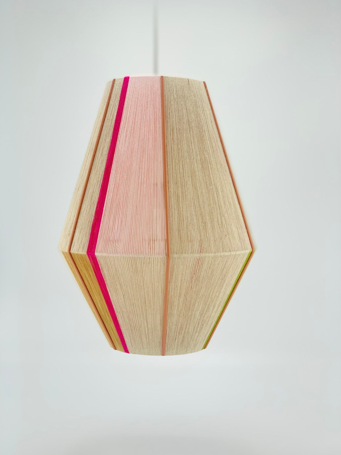 Lana Baya pendant light handwoven in bright pink, rose, gold, and natural yarns by Skye Lightly