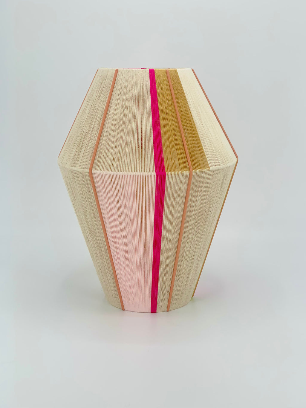 Lana Baya pendant light handwoven in bright pink, rose, gold, and natural yarns by Skye Lightly