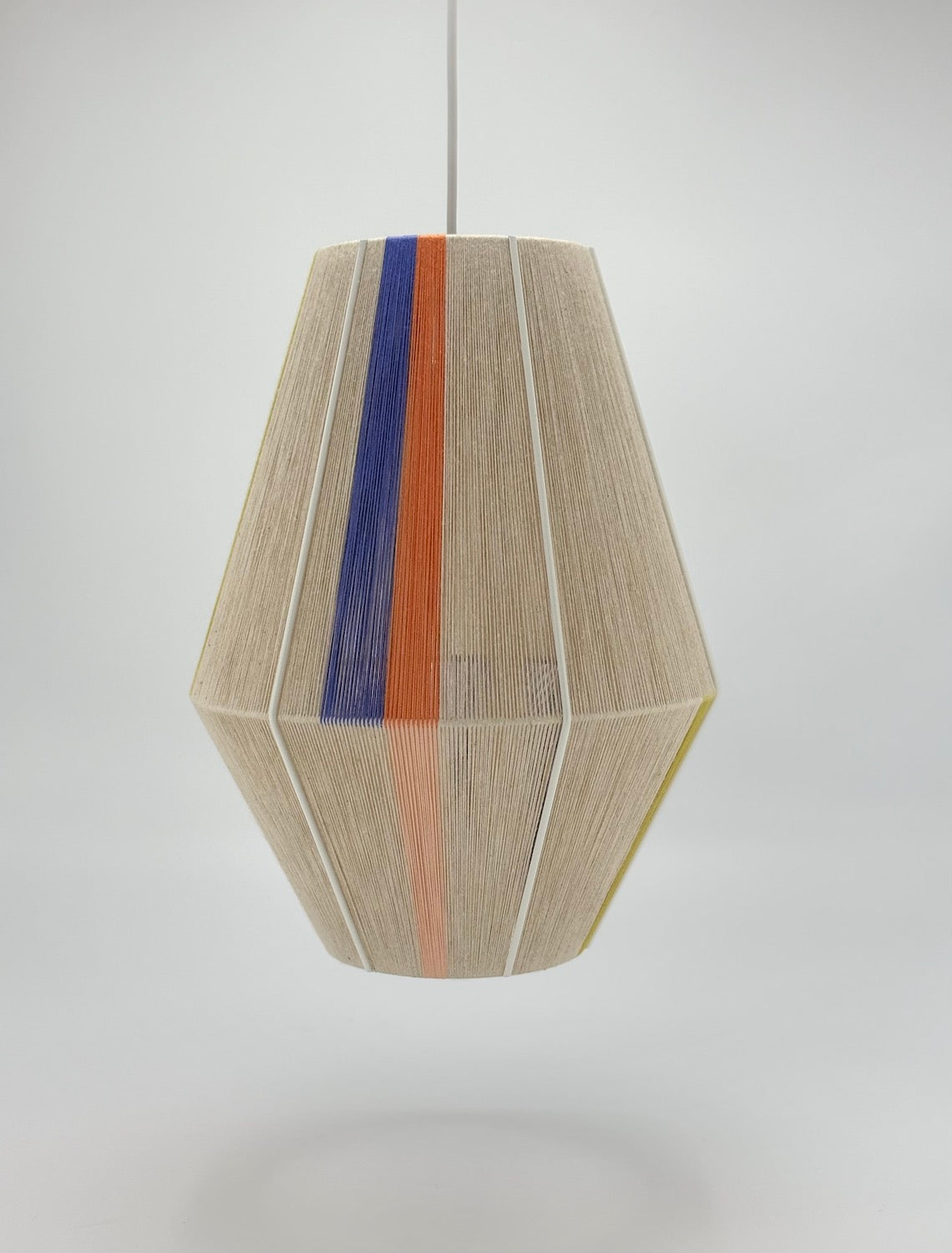 Parker Baya pendant light handwoven in orange, peach and periwinkle yarns by Skye Lightly