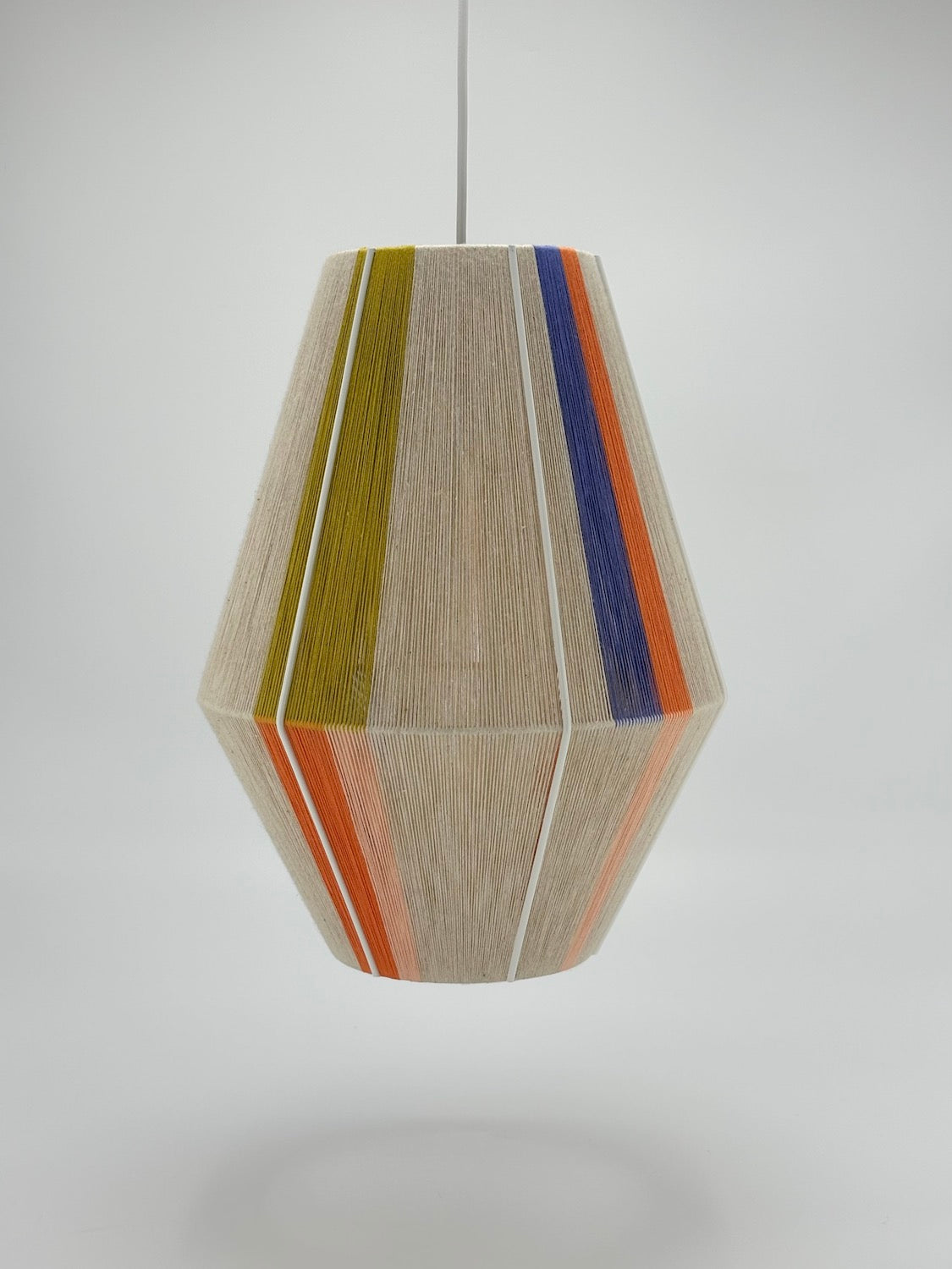 Parker Baya pendant light handwoven in mustard, orange, peach and periwinkle yarns by Skye Lightly
