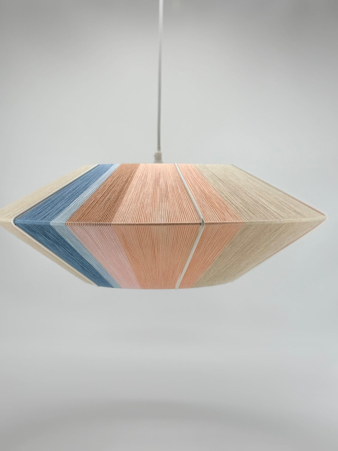 off-middle-view-Jean Orb pendant light handwoven in cinnamon, peach, chambray, salmon, pale rose and natural yarns by Skye Lightly