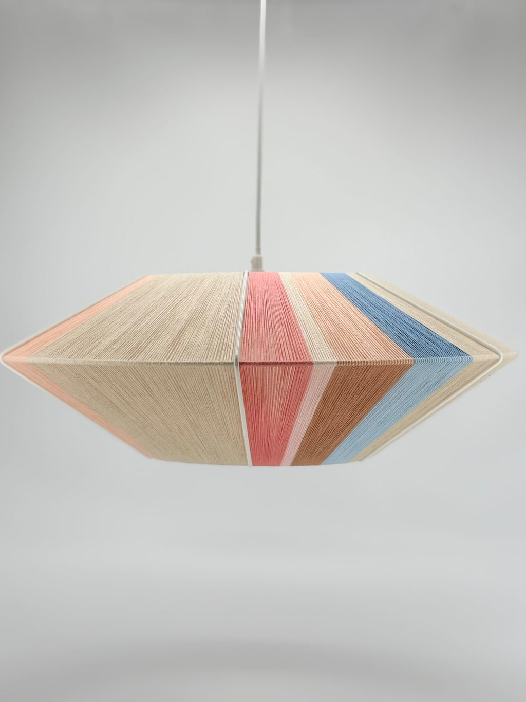 side middle view of Jean Orb pendant light handwoven in cinnamon, peach, chambray, salmon, pale rose and natural yarns by Skye Lightly
