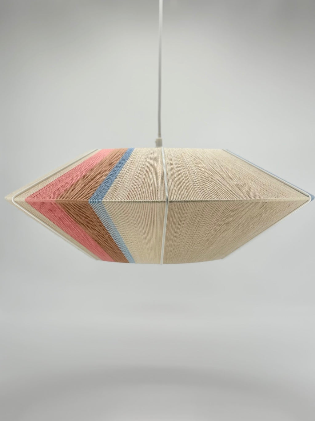 Jean Orb pendant light handwoven in cinnamon, peach, chambray, salmon, pale rose and natural yarns by Skye Lightly