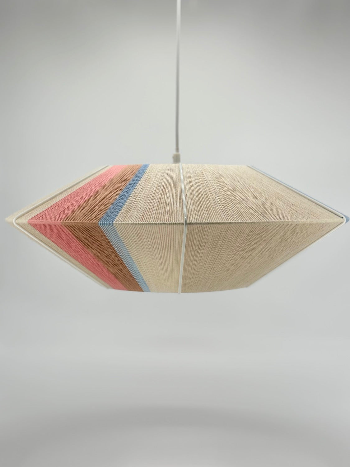 Jean Orb pendant light handwoven in cinnamon, peach, chambray, salmon, pale rose and natural yarns by Skye Lightly