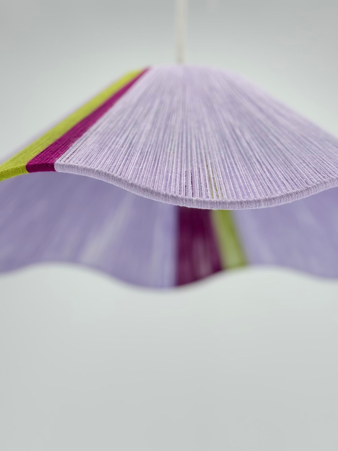 bottom view of iona Wave pendant light in lilac with green and raspberry stripes, handwoven by Skye Lightly.