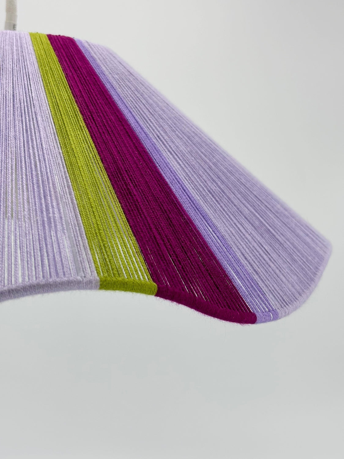 closeup of iona Wave pendant light in lilac with green and raspberry stripes, handwoven by Skye Lightly.