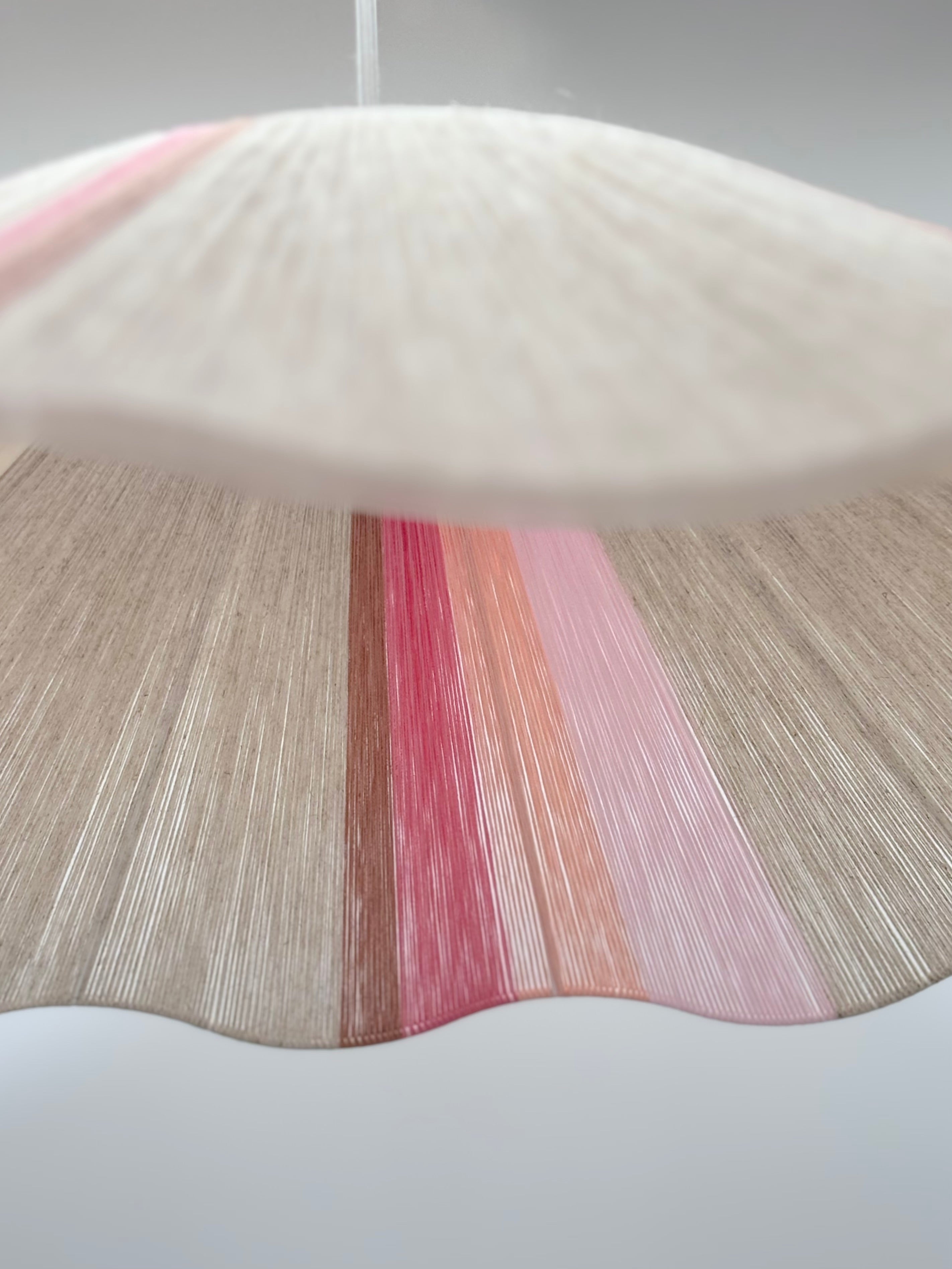 Bottom view of handwoven Knox wave pendant light in soft pink and natural tones by Skye Lightly.