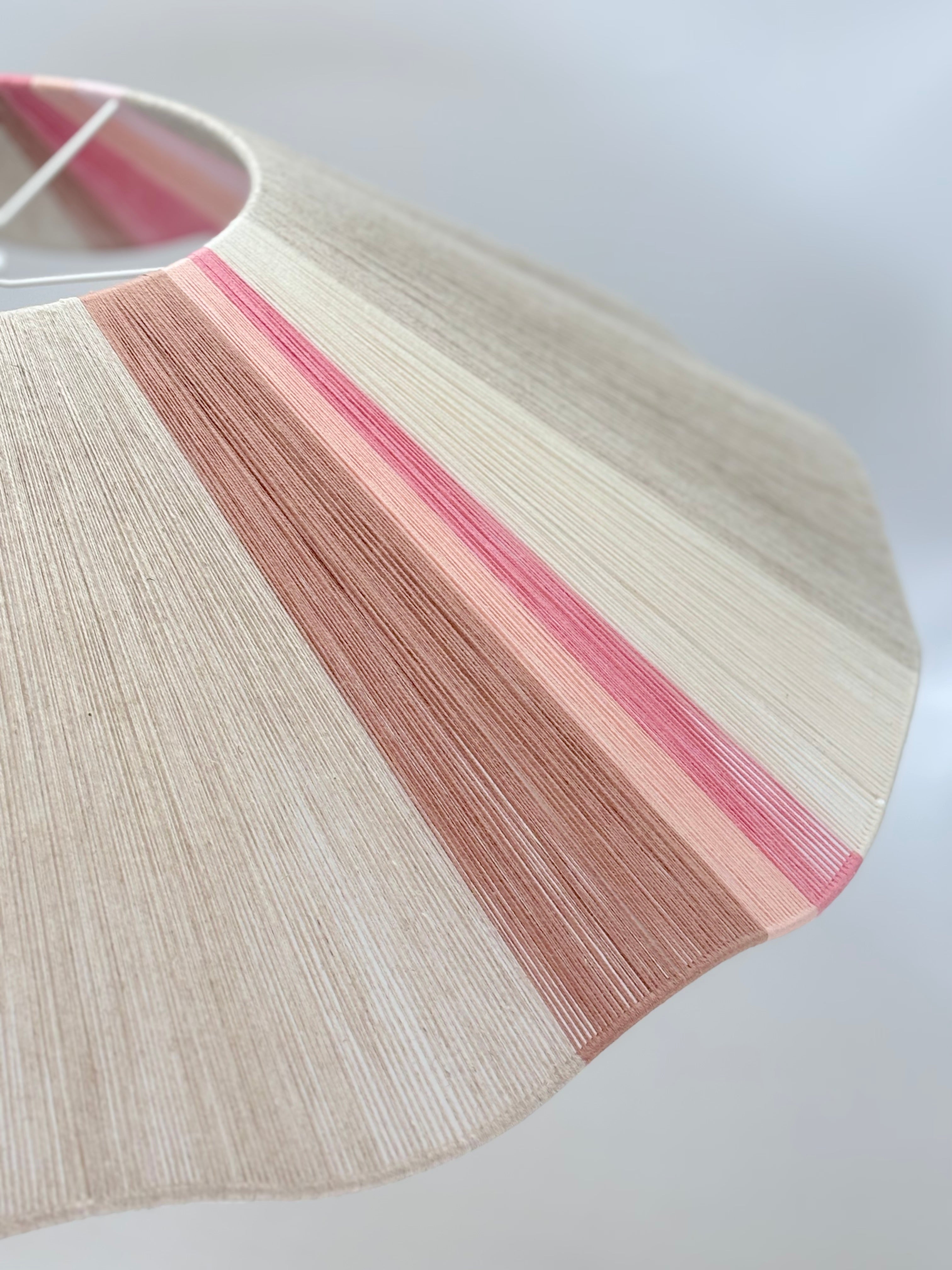 side view of handwoven Knox wave pendant light in soft pink and natural tones by Skye Lightly.
