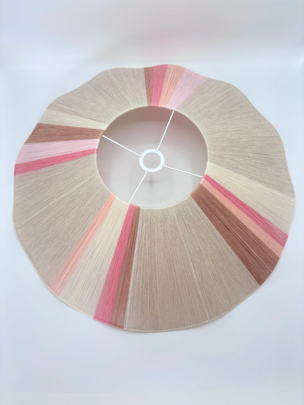 Top view of handwoven Knox wave pendant light in soft pink and natural tones by Skye Lightly.