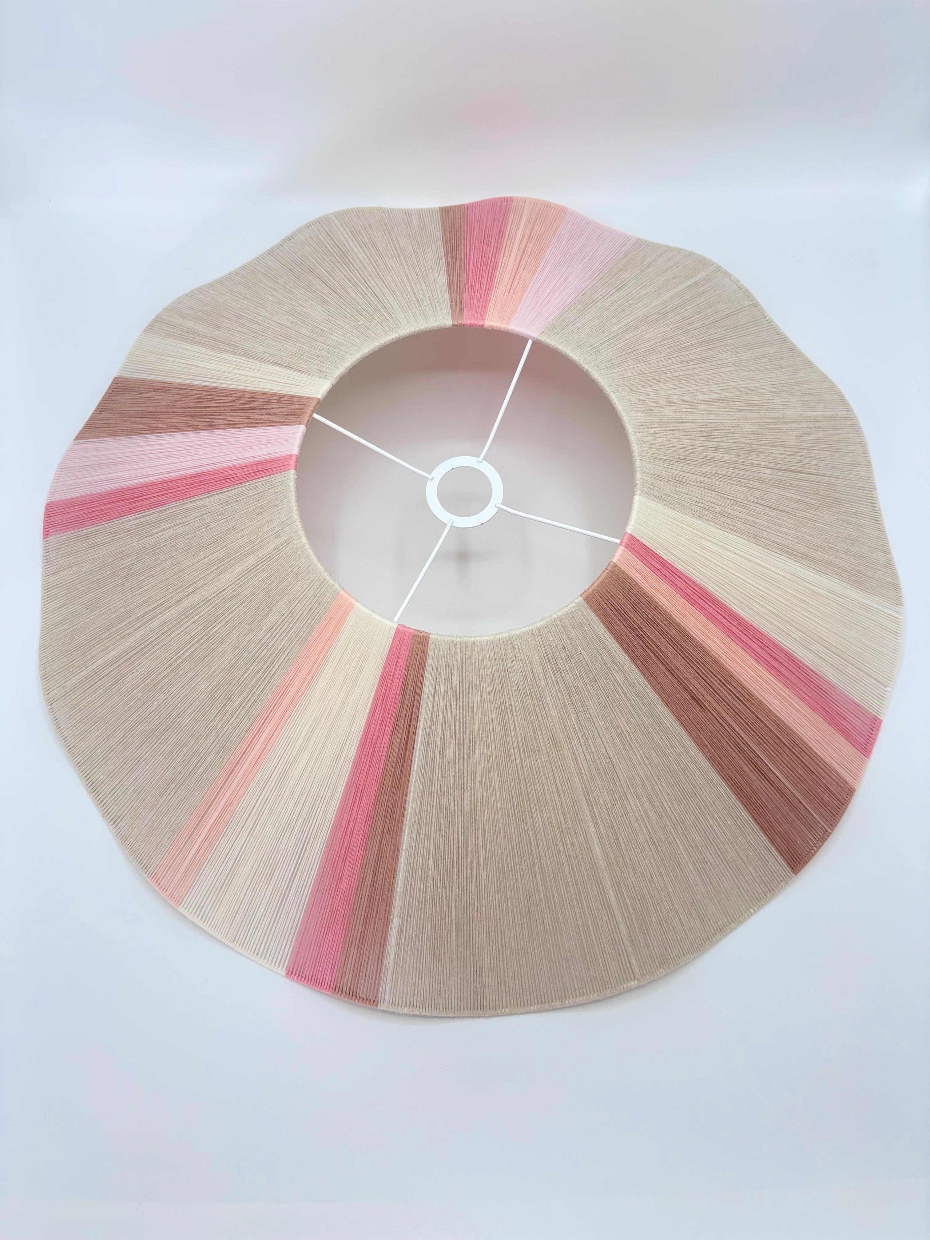 Top view of handwoven Knox wave pendant light in soft pink and natural tones by Skye Lightly.