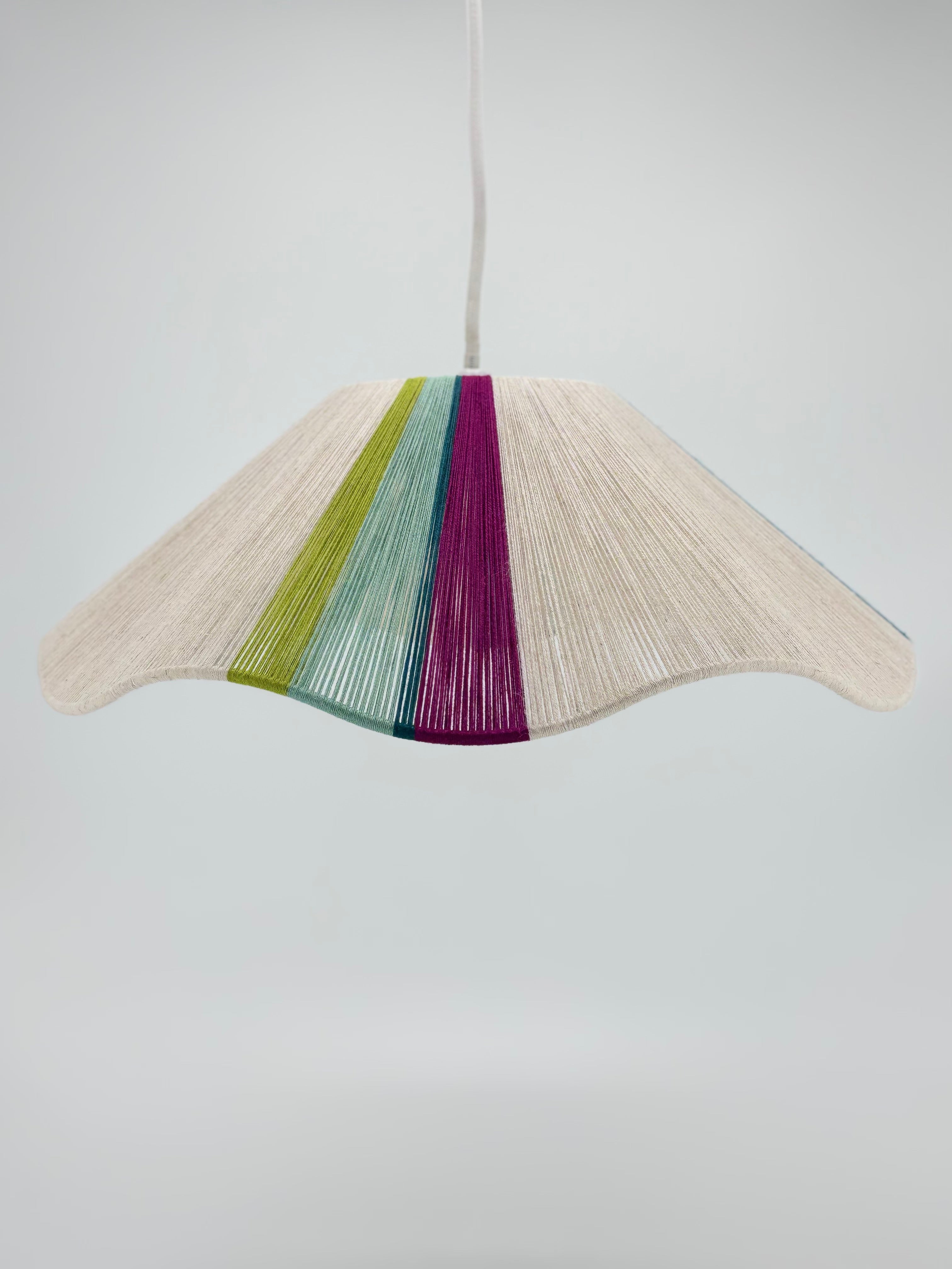 Front view of sono Wave pendant light handwoven in lime, magenta, teal, turquoise and natural yarns by Skye Lightly.