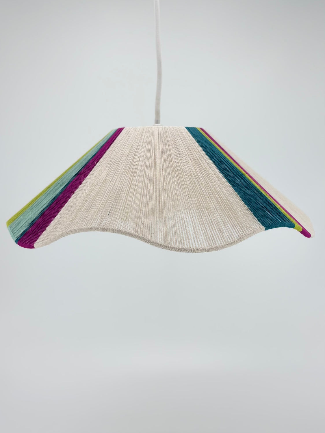 middle view of sono Wave pendant light handwoven in lime, magenta, teal, turquoise and natural yarns by Skye Lightly.