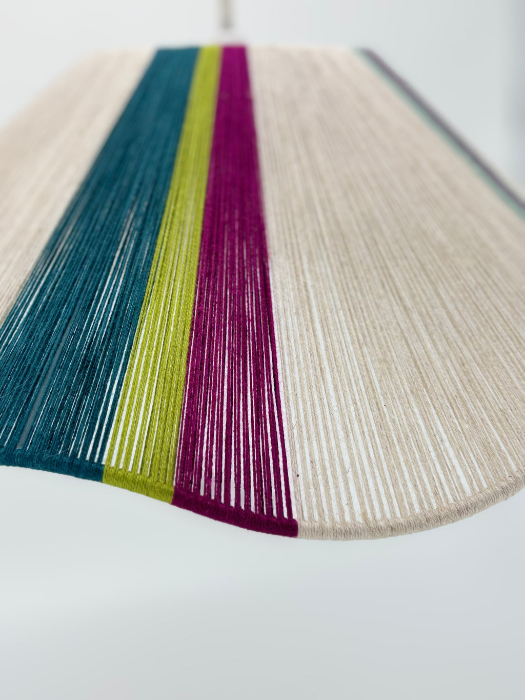 zoomed view of sono Wave pendant light handwoven in lime, magenta, teal, turquoise and natural yarns by Skye Lightly.
