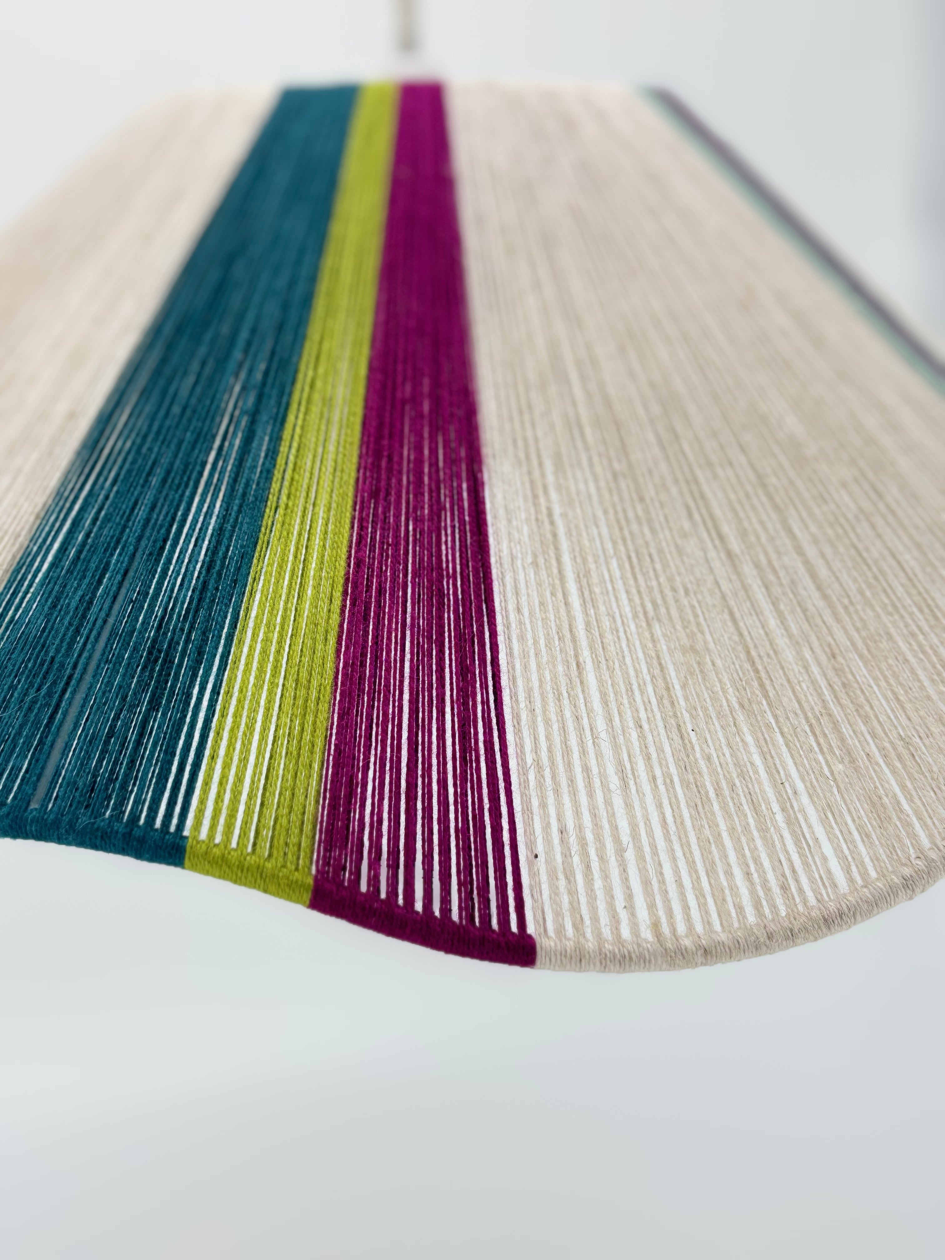 zoomed view of sono Wave pendant light handwoven in lime, magenta, teal, turquoise and natural yarns by Skye Lightly.