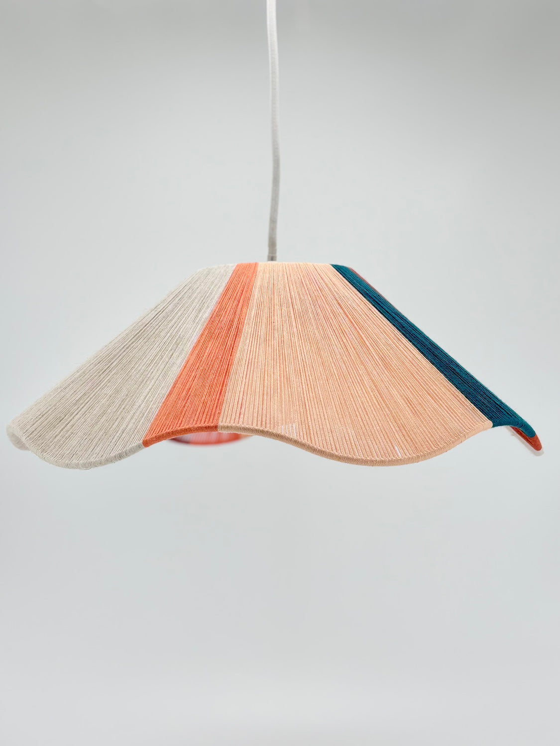 Venice Wave pendant light handwoven in peach, teal, burgundy and natural yarns by Skye Lightly