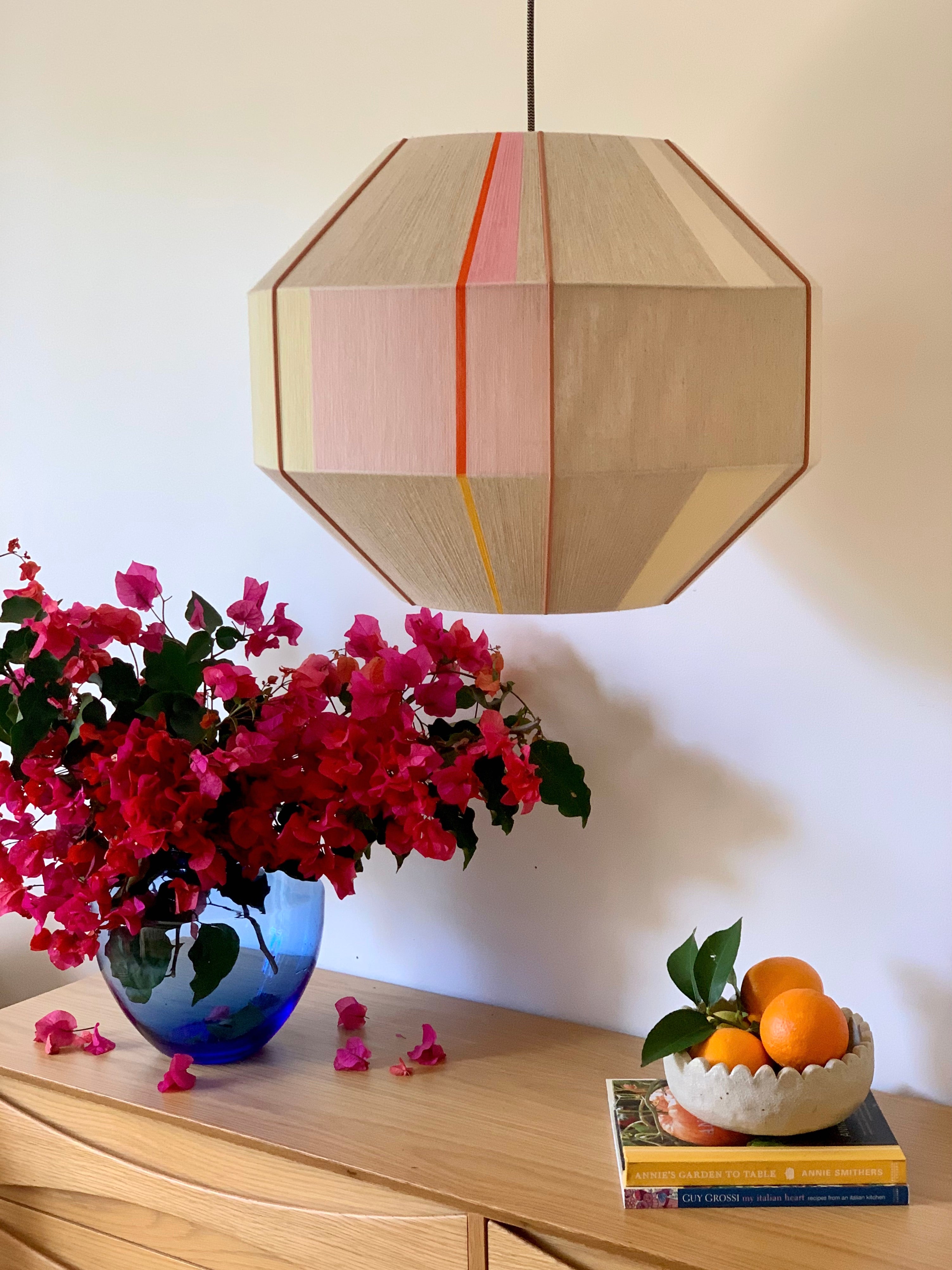 Amor Hive pendant light handwoven in blush, eucalyptus, lilac and natural yarns by Skye Lightly
