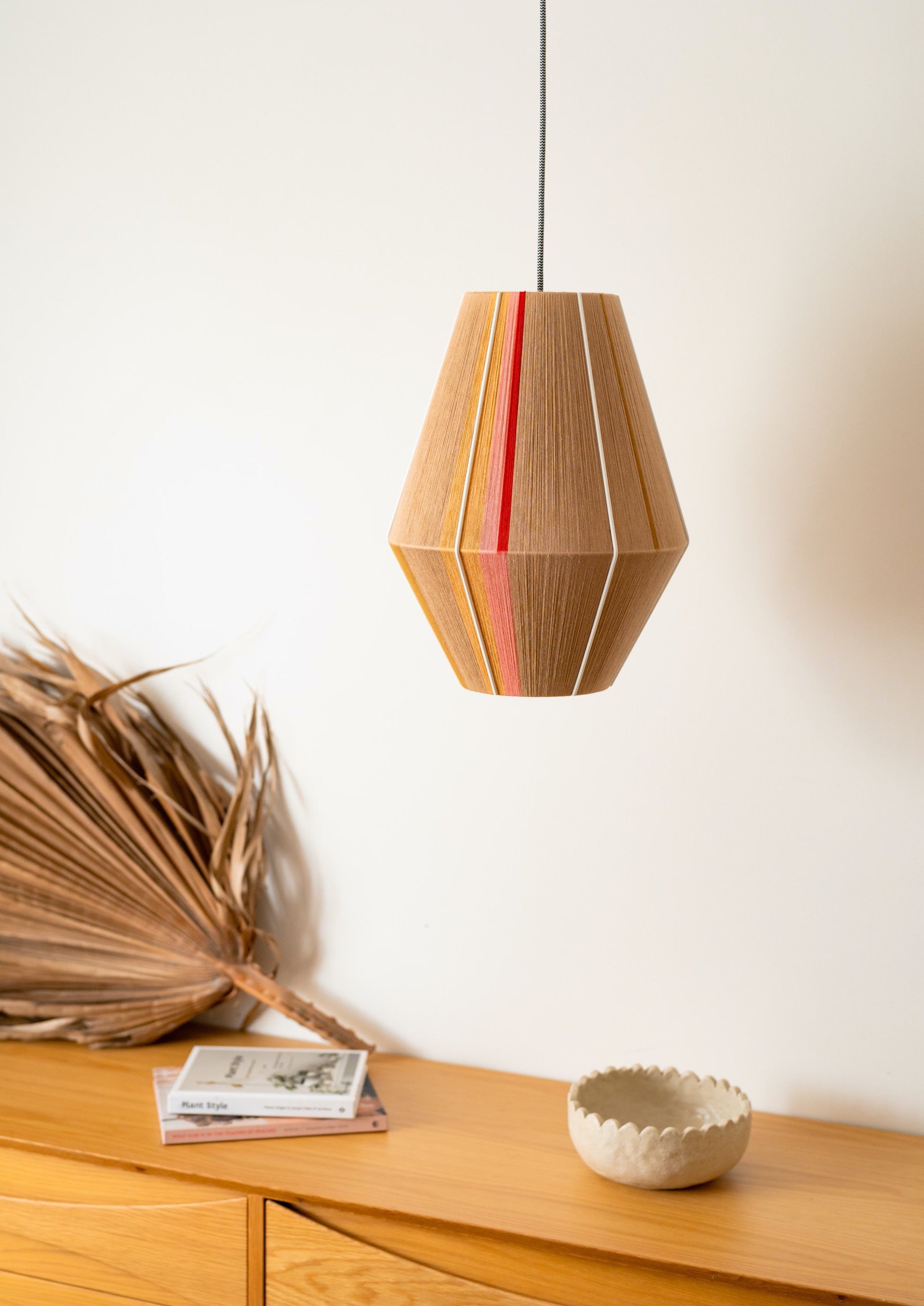 Catherine Baya pendant light handwoven in mustard, sage, peach and natural yarns by Skye Lightly
