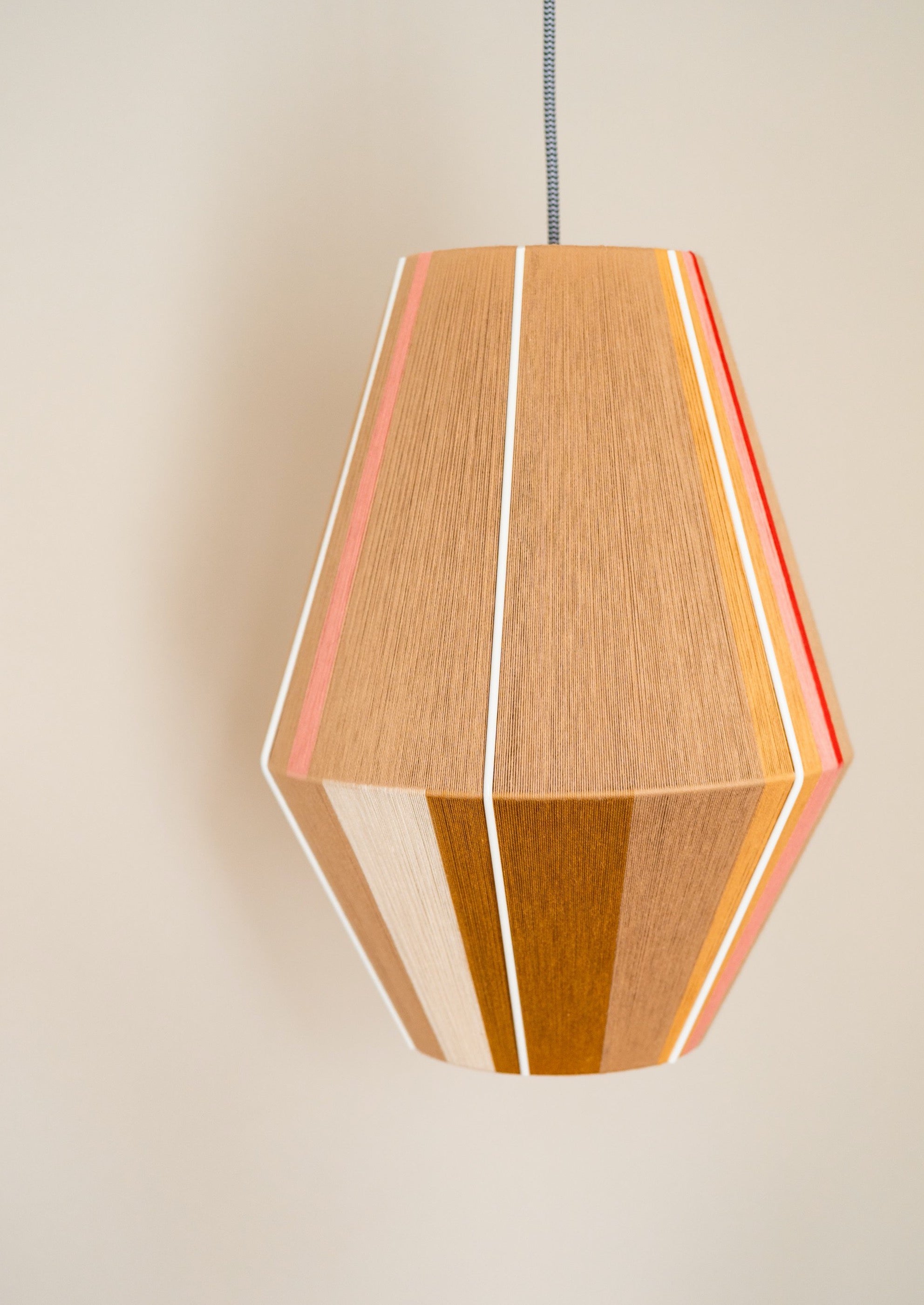 Catherine Baya pendant light handwoven in mustard, sage, peach and natural yarns by Skye Lightly
