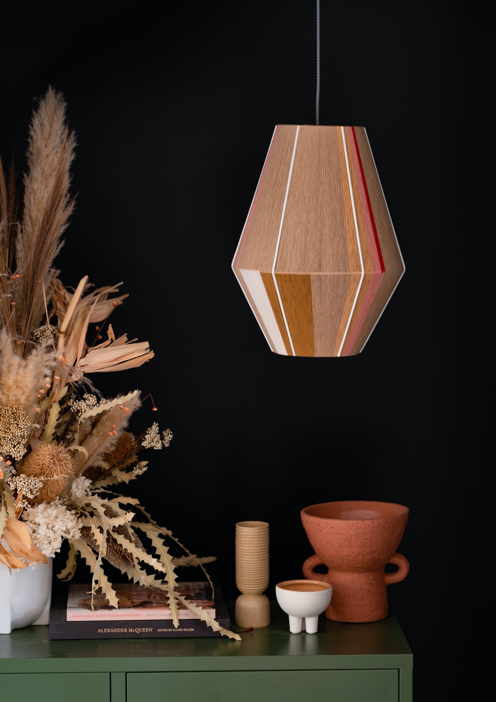 Catherine Baya pendant light handwoven in mustard, sage, peach and natural yarns by Skye Lightly
