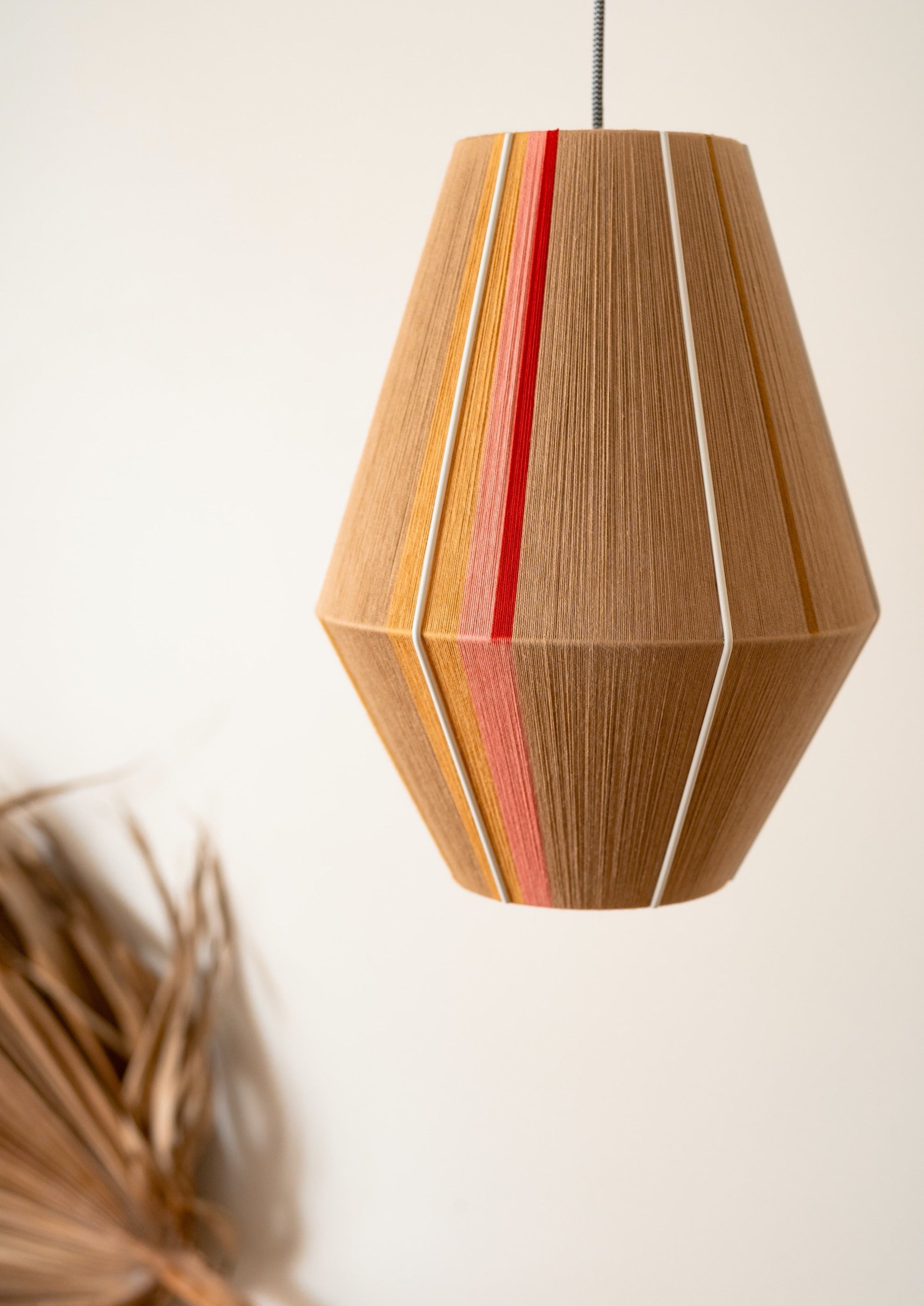 Catherine Baya pendant light handwoven in mustard, sage, peach and natural yarns by Skye Lightly
