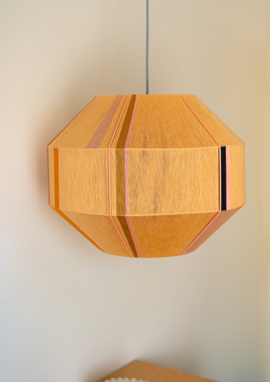 Charlotte Hive pendant light handwoven in sage, peach, periwinkle and natural yarns by Skye Lightly
