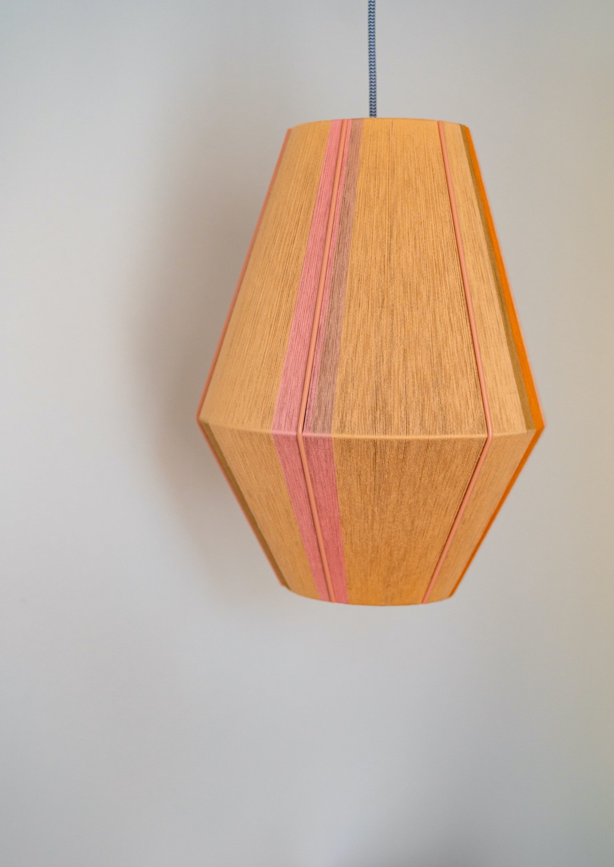 Keaton Baya pendant light handwoven in navy, mustard, coral and natural yarns by Skye Lightly
