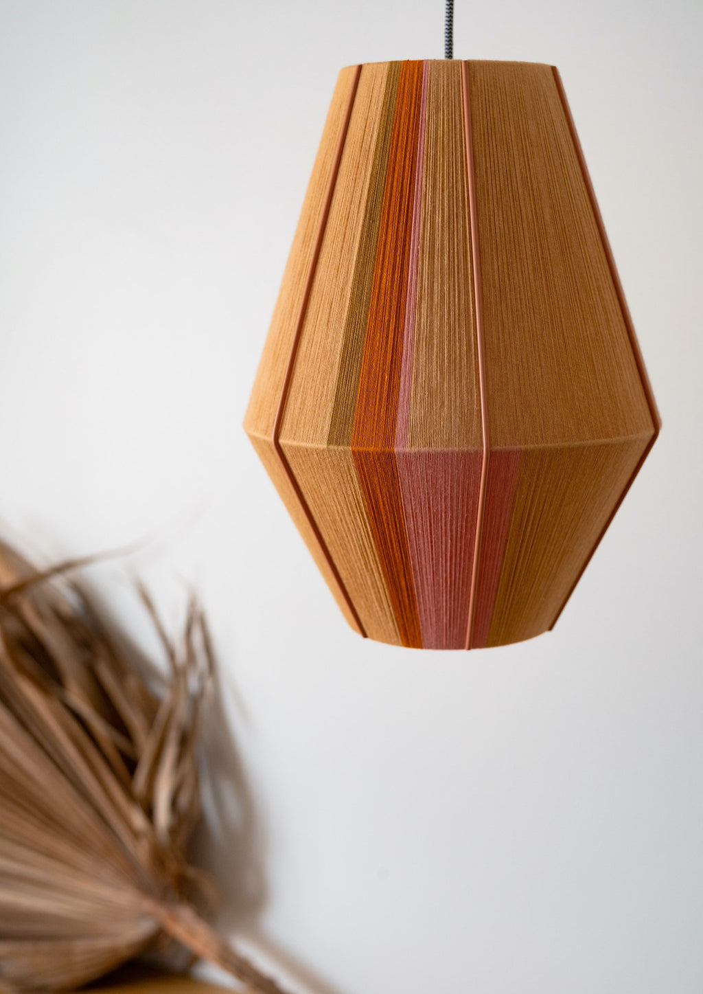 Keaton Baya pendant light handwoven in navy, mustard, coral and natural yarns by Skye Lightly
