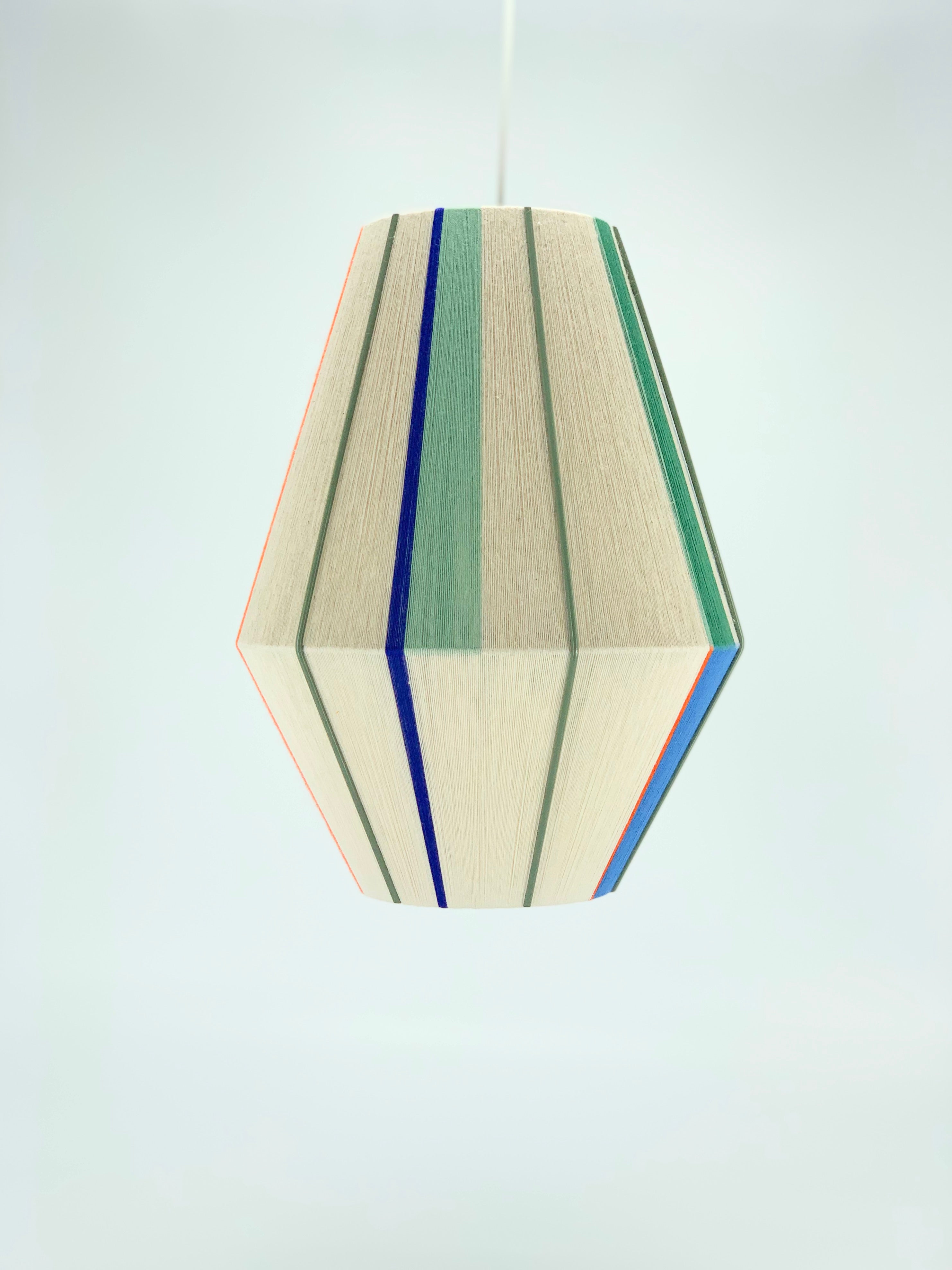Luca Baya pendant light handwoven in navy, mustard, lilac, and natural yarns by Skye Lightly

