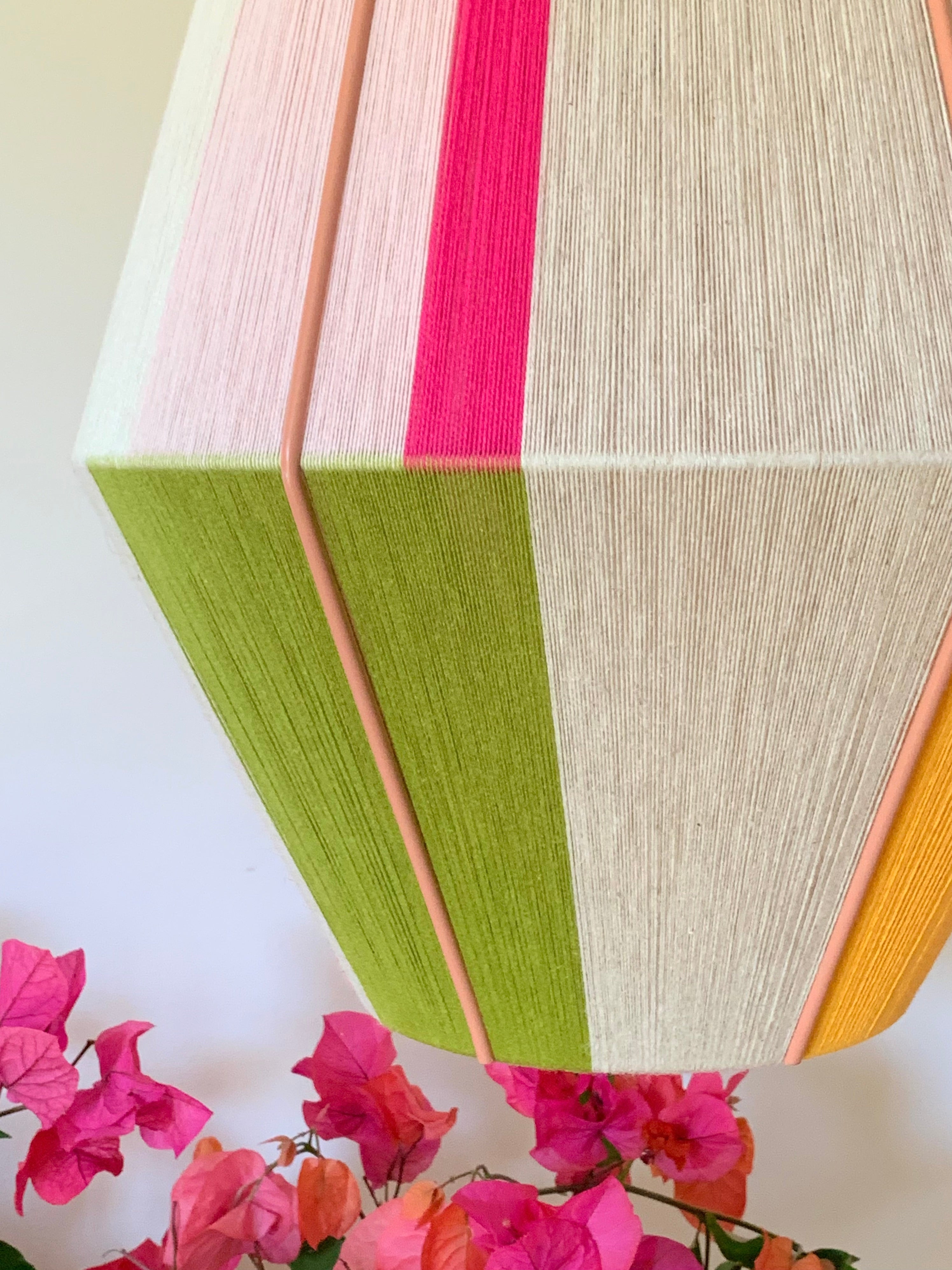 Lifestyle closeup image of Sofia Baya pendant light handwoven in blush, lavender, buttercup yellow, and natural yarns by Skye Lightly