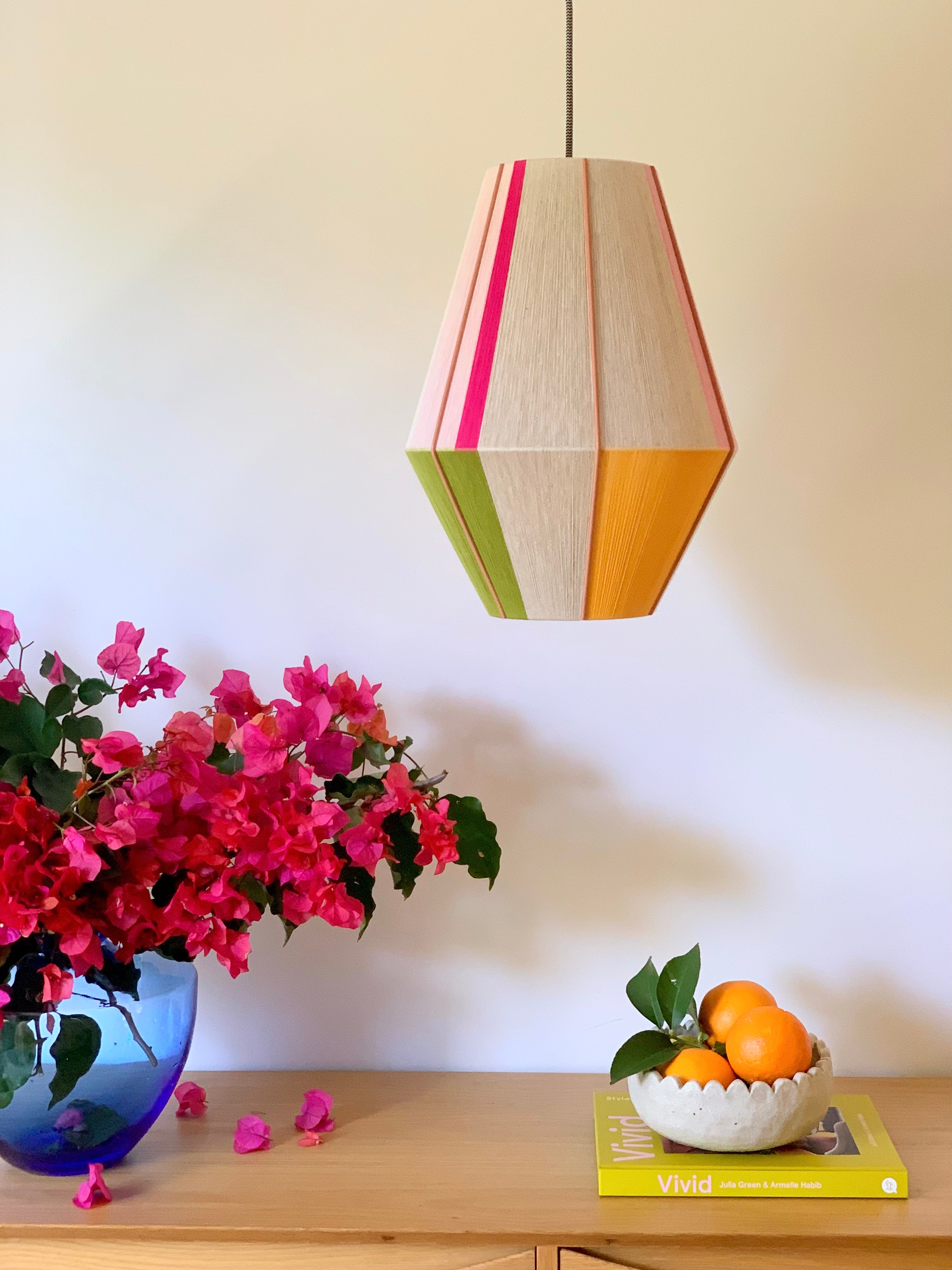 Lifestyle Sofia Baya pendant light handwoven in blush, lavender, buttercup yellow, and natural yarns by Skye Lightly
